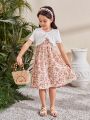 SHEIN Kids SUNSHNE Young Girls' Round Neck Short Sleeve Top With Ruffle Trim And Spaghetti Strap Floral Dress Set