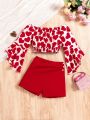 SHEIN Kids CHARMNG Tween Girl Love Heart Print Off Shoulder Top With Flare Sleeves And Solid Colored Shorts 2pcs/Set