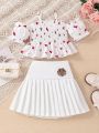 SHEIN Kids FANZEY Toddler Girls' Floral Off Shoulder Shirred Blouse With Puff Sleeves & Academy Patch Pleated Skirt 2pcs/Set For Spring/Summer