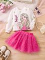 SHEIN Kids KDOMO Young Girl Character & Letter Printed Top With Heart Mesh Tutu Skirt Two Piece Set