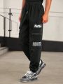 SHEIN Men Slogan Graphic Drawstring Waist Flap Pocket Side Pants