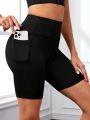 SHEIN Yoga Basic Solid Color Elastic Waistband Sports Shorts With Phone Pocket (Plus Size)