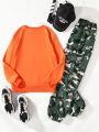 SHEIN Kids Y2Kool Tween Girl Figure & Slogan Graphic Pullover & Camo Print Pants