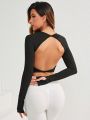 Black Sports Top With Open Back, Long Sleeves And Thumb Hole