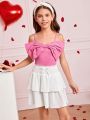 SHEIN Kids CHARMNG Tween Girls' Woven Solid Color Spaghetti Strap Top With Bowknot Detail And Woven Layered Skirt Set