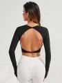 Black Sports Top With Open Back, Long Sleeves And Thumb Hole