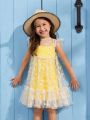 SHEIN Kids QTFun Young Girl Two Pieces Set Of Solid Color Spaghetti Strap Dress And Daisy Print Mesh Dress With Flying Sleeves