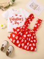 SHEIN Kids EVRYDAY Toddler Girls' Cute Sweetheart Heart Print T-Shirt And Ruffle Hem Suspender Skirt With Decorative Edging, Casual Style