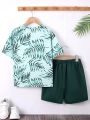 SHEIN Kids SUNSHNE Tween Boys' Vacation Style Round Neck Short Sleeve Knitwear Top With Leaf Print And Solid Color Woven Shorts 2pcs/set