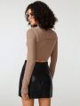 Manon Gautier Mock Neck Cut Out Front Crop Top