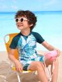 Young Boy's Random Tropical Printed Color Block Short Sleeve Swimsuit With Padded Shoulders And Shorts