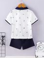 SHEIN Kids Nujoom Toddler Boys' Casual College Style Printed Polo Shirt And Solid Color Shorts Set