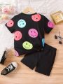 SHEIN Kids Cooltwn Little Girls' Smiling Face Printed Short Sleeve T-Shirt And Shorts Set