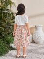 SHEIN Kids SUNSHNE Young Girls' Round Neck Short Sleeve Top With Ruffle Trim And Spaghetti Strap Floral Dress Set