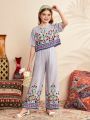 SHEIN Kids Nujoom 2pcs Tween Girl's Cute Round Neck Vacation Striped Floral Printed Shirt And Pants Set