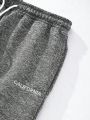 Men Letter Graphic Flap Pocket Split Hem Drawstring Waist Sweatpants