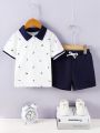 SHEIN Kids Nujoom Toddler Boys' Casual College Style Printed Polo Shirt And Solid Color Shorts Set