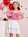 SHEIN Kids CHARMNG Tween Girls' Woven Solid Color Spaghetti Strap Top With Bowknot Detail And Woven Layered Skirt Set