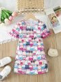 SHEIN Kids QTFun Young Girl'S Cute Printed Dress With Pom Pom Fringe And Flounce Sleeve, Suitable For Summer