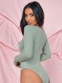 SHEIN BAE Solid Color Hollow Out Long Sleeve Bodysuit