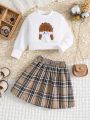 SHEIN Kids EVRYDAY Toddler Girls' Doll Embroidery Top And Multicolor Plaid Skirt 2-Piece Set