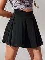 SHEIN Teenage Girls' Solid Color Skorts With Built-In Light Blocking Shorts And Pockets For Casual & Sports Wear