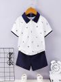 SHEIN Kids Nujoom Toddler Boys' Casual College Style Printed Polo Shirt And Solid Color Shorts Set