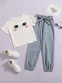 SHEIN Kids QTFun Girls Cartoon Graphic Tee & Paper Bag Waist Belted Pants