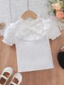 SHEIN Kids Y2Kool Little Girls' Preppy Style Stand Collar Short Sleeve Peter Pan Collar Shirt With 3d Bowknot And Ruffled Hem Summer