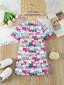 SHEIN Kids QTFun Young Girl'S Cute Printed Dress With Pom Pom Fringe And Flounce Sleeve, Suitable For Summer