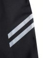 Teen Boys' Classic Sporty And Versatile Long Pants, Suitable For Sports, Outdoors And Indoors. Black Color With Reflective Stripes And Printed Design, Features Zipper At Foot, High Stretch, Skin-Friendly, Soft And Comfortable Fabric,